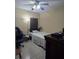 Bedroom with a full bed, desk, and gaming chair in a cozy setting, complete with neutral walls and a minimalist design at 10722 Clover Walk Dr, Orlando, FL 32825