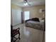 Inviting bedroom with a ceiling fan, tile flooring, and a closet for convenient storage at 10722 Clover Walk Dr, Orlando, FL 32825
