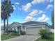 Lovely single-story home with an attached garage, lush landscaping, and stone accents at 10722 Clover Walk Dr, Orlando, FL 32825