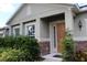 Beautiful home entrance with stone accents, manicured bushes, and a well-lit, welcoming doorway at 10722 Clover Walk Dr, Orlando, FL 32825