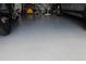 Epoxy painted garage floor with bikes, motorcycle, and car in background at 10722 Clover Walk Dr, Orlando, FL 32825
