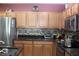 Bright kitchen features wooden cabinetry, stainless steel appliances, and decorative backsplash at 10722 Clover Walk Dr, Orlando, FL 32825