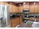 Kitchen featuring stainless steel appliances, ample cabinet space, and granite countertops at 10722 Clover Walk Dr, Orlando, FL 32825