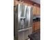 Modern kitchen featuring a stainless steel refrigerator and warm wood cabinetry at 10722 Clover Walk Dr, Orlando, FL 32825