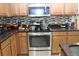 Functional kitchen with stainless steel appliances, granite countertops, and ample cooking space at 10722 Clover Walk Dr, Orlando, FL 32825