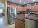 Modern kitchen features stainless steel appliances, granite countertops, tile backsplash, and ample cabinet space at 10722 Clover Walk Dr, Orlando, FL 32825