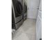 Laundry room with a side-by-side washer and dryer on risers, offering convenience and efficiency for household chores at 10722 Clover Walk Dr, Orlando, FL 32825
