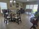 Bright living room with tile flooring, glass-top dining table, and comfortable seating at 10722 Clover Walk Dr, Orlando, FL 32825