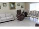Living room features neutral walls, tile floors, and comfortable seating options at 10722 Clover Walk Dr, Orlando, FL 32825