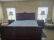 Cozy main bedroom showcases a comfortable bed, two chairs, side tables, and plenty of natural light at 10722 Clover Walk Dr, Orlando, FL 32825