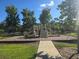 Community playground featuring multiple slides, climbing structures, and a wood chip safety surface at 10722 Clover Walk Dr, Orlando, FL 32825