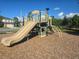 Community playground featuring slides, climbing structures, and a wood chip safety surface at 10722 Clover Walk Dr, Orlando, FL 32825