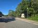 Community entrance featuring lush landscaping and a welcoming monument sign, creating a positive first impression at 10722 Clover Walk Dr, Orlando, FL 32825