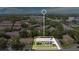 Aerial view of a property with a white outline in a neighborhood near roadways with plenty of trees at 12155 Pepperdine Pl, Orlando, FL 32826