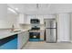 Updated kitchen boasts stainless steel appliances and quartz countertops at 12155 Pepperdine Pl, Orlando, FL 32826