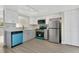 Modern kitchen with stainless steel appliances, white cabinetry, and quartz countertops at 12155 Pepperdine Pl, Orlando, FL 32826