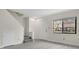 Bright living room features gray wood floors, stairs, and a large window at 12155 Pepperdine Pl, Orlando, FL 32826