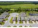 Wide aerial view of homes with brick driveways, green space and pond in the background at 1309 Lombardi Ct, Kissimmee, FL 34759