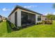 The screened-in patio complements the manicured lawn and backyard of this home at 1309 Lombardi Ct, Kissimmee, FL 34759