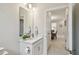 Well-lit bathroom with a sleek vanity and a view into the dining room at 1309 Lombardi Ct, Kissimmee, FL 34759