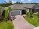 Aerial view of a beautiful home featuring a brick driveway and a screened in patio at 1309 Lombardi Ct, Kissimmee, FL 34759