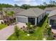 Aerial view of a well-maintained single-Gathering home with landscaped front yard and brick driveway at 1309 Lombardi Ct, Kissimmee, FL 34759