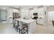 Modern kitchen with white cabinets, stainless steel appliances, and a large island with seating at 1309 Lombardi Ct, Kissimmee, FL 34759