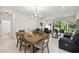 Open-concept living room featuring a dining area, leather sofa, and sliding glass doors to lanai at 1309 Lombardi Ct, Kissimmee, FL 34759