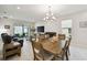 Open-concept living area with dining and living room furniture, and sliding doors to the outdoor patio at 1309 Lombardi Ct, Kissimmee, FL 34759
