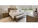 Beautifully staged main bedroom with wood furniture, natural light, and comfortable seating at 1309 Lombardi Ct, Kissimmee, FL 34759