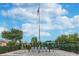 Patriotic memorial site with American flags, stone monuments, benches, and manicured landscaping under a bright sky at 1309 Lombardi Ct, Kissimmee, FL 34759