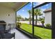 View from screened-in patio overlooking a landscaped backyard with palm trees at 1309 Lombardi Ct, Kissimmee, FL 34759