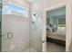Contemporary walk-in shower with marble tiling and a convenient built-in shelf at 1309 Lombardi Ct, Kissimmee, FL 34759
