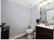 Clean bathroom with wood-look flooring, vanity, and modern fixtures at 13129 Cog Hill Way, Orlando, FL 32828