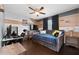 A comfy bedroom provides a relaxing retreat with a ceiling fan, desk and a daybed for flexible living at 13129 Cog Hill Way, Orlando, FL 32828