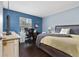 Comfortable bedroom offers a cozy workspace and sleeping area, with great natural light and calming paint at 13129 Cog Hill Way, Orlando, FL 32828