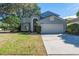 Charming two-story home with attached two-car garage, manicured lawn and mature trees at 13129 Cog Hill Way, Orlando, FL 32828