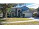 Charming two-story home with attached two-car garage, manicured lawn and mature trees at 13129 Cog Hill Way, Orlando, FL 32828