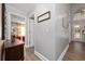 Entry hallway featuring modern decor, natural lighting, and wood-look flooring at 13129 Cog Hill Way, Orlando, FL 32828