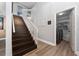 Hallway features elegant wood stairs with white railing, wood laminate floors, and access to the laundry room at 13129 Cog Hill Way, Orlando, FL 32828