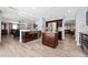 Open concept kitchen with stainless steel appliances, center island, and view into living area at 13129 Cog Hill Way, Orlando, FL 32828