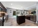 Updated kitchen with center island, stainless steel appliances, and sliding door access to the pool at 13129 Cog Hill Way, Orlando, FL 32828