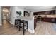 Open kitchen featuring dark wood cabinets, stainless steel appliances, and breakfast bar with stools at 13129 Cog Hill Way, Orlando, FL 32828