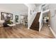 Open-concept living area featuring hardwood floors, staircase, and a seamless transition to the dining space at 13129 Cog Hill Way, Orlando, FL 32828