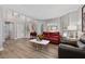 Bright living room with hardwood floors, neutral walls, and plenty of natural light at 13129 Cog Hill Way, Orlando, FL 32828