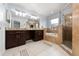 Luxurious bathroom featuring a double vanity, soaking tub, tiled shower, and a light neutral color palette at 13129 Cog Hill Way, Orlando, FL 32828