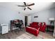 Comfortable home office with desk space, red seating, and ample natural light at 13129 Cog Hill Way, Orlando, FL 32828