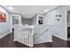 Bright staircase landing with dark wood floors, white railing, and decorative wall accents at 13129 Cog Hill Way, Orlando, FL 32828