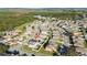 Community aerial view shows numerous residences and surrounding lush greenery and native landscapes at 1383 Buckeye Trace Blvd, Winter Haven, FL 33881