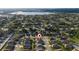 Overhead neighborhood view showcases homes near a scenic lake and surrounded by lush trees and winding roads at 1383 Buckeye Trace Blvd, Winter Haven, FL 33881